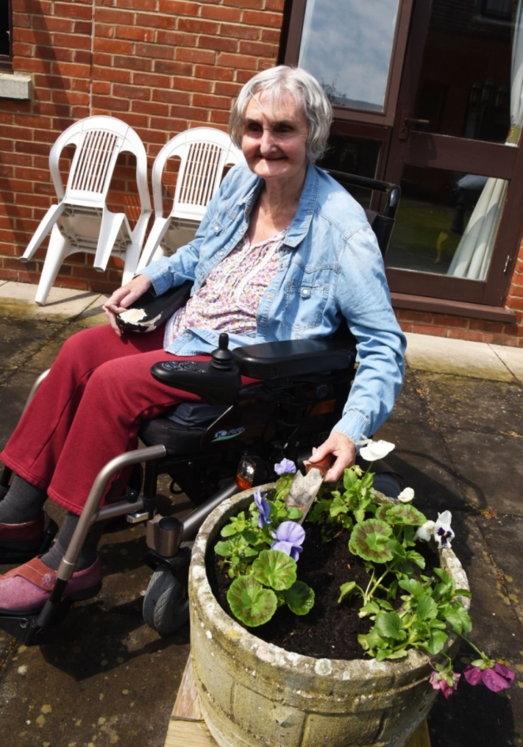Resident Jean Cherrington planting some flowers