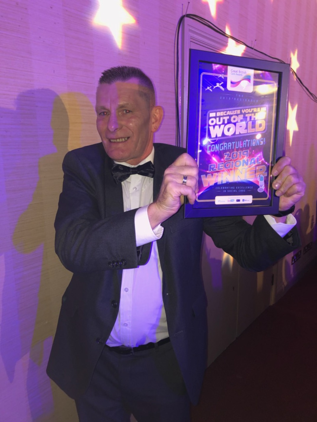 Billy celebrating with his award